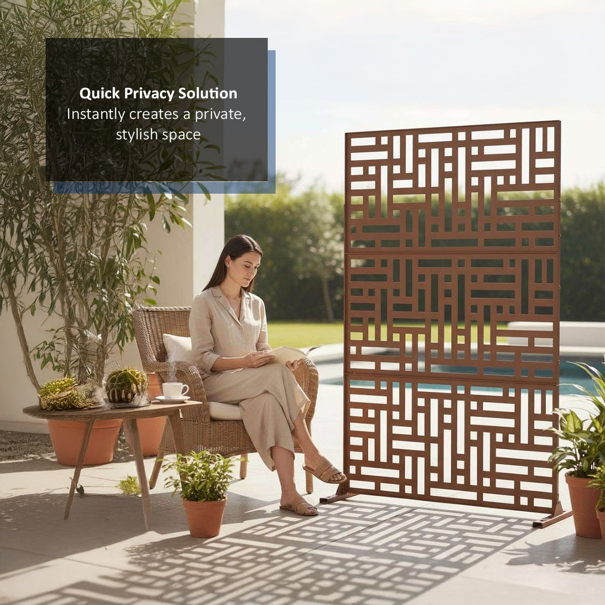 A person sitting on a patio with a decorative outdoor privacy screen