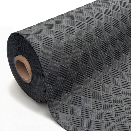 Close-up of a black rubber matting roll with a textured checker-plate pattern, partially unrolled on a white background.