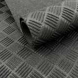 Close-up of black Eco Deckplate rubber flooring showing a textured anti-slip checker-plate pattern