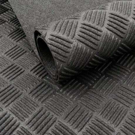 Close-up of black Eco Deckplate rubber flooring showing a textured anti-slip checker-plate pattern